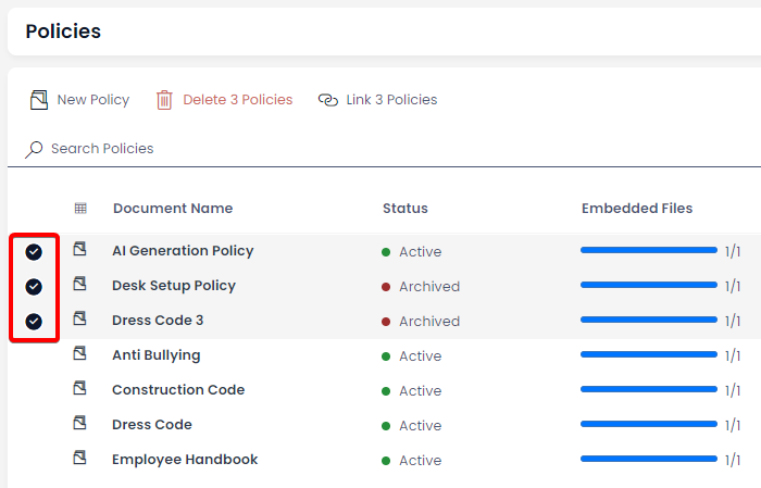 A screenshot of the user selecting multiple items from the Policies data table. The policies have been selected, and this is visible due to the subtle grey background behind each item row, and the black, circle selection circles that contain a white checkmark. Three policies have been selected: AI Generation Policy, Desk Setup Policy, and Dress Code 3. The screenshot is annotated with a red box to highlight the selection circles.